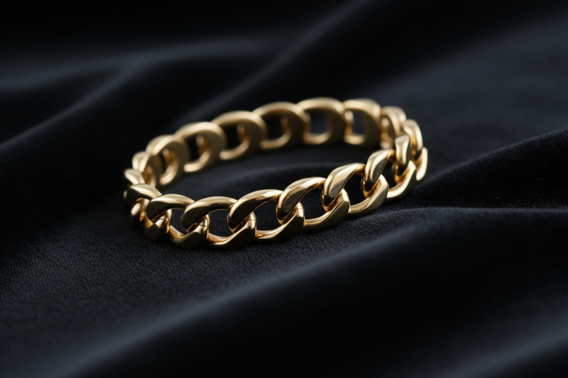 Generate an image of a gold brtacelet on a black cloth